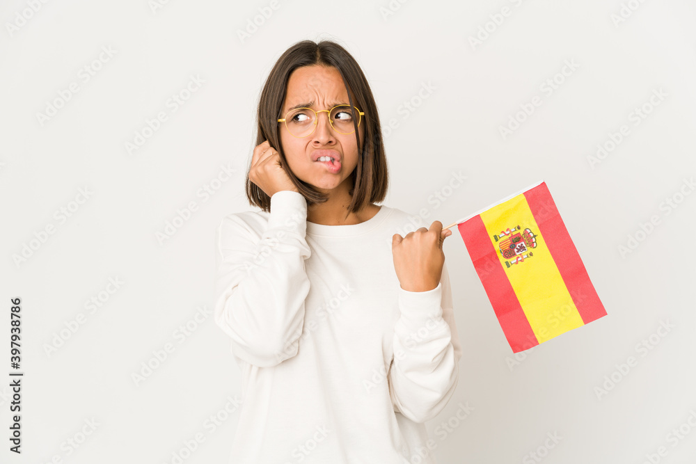 Young hispanic mixed race woman holding a spanish flag covering ears with hands. Young hispanic mixed race woman holding a spanish flag covering ears with hands.