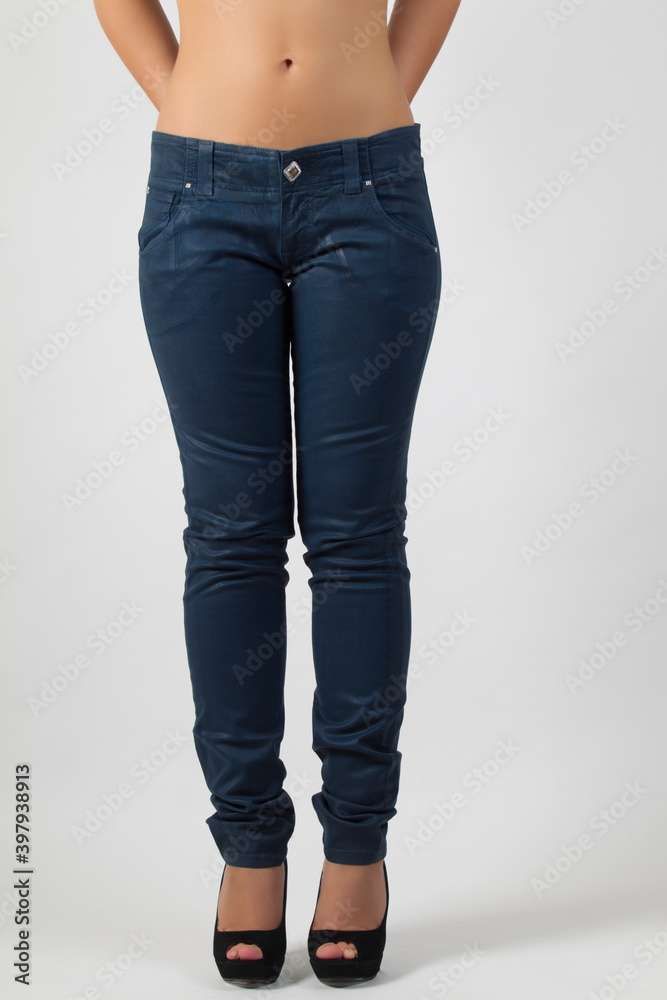 Bare belly young woman wearing blue tight jeans Bare belly young woman wearing blue tight jeans