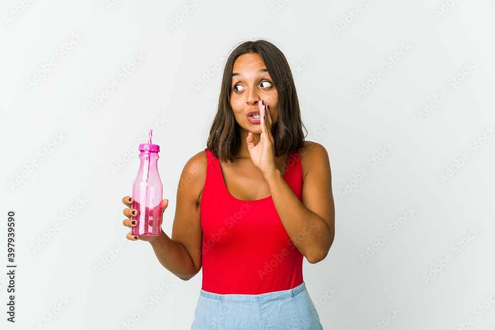 Young latin woman holding a milkshake isolated on white background Young latin woman holding a milkshake isolated on white background