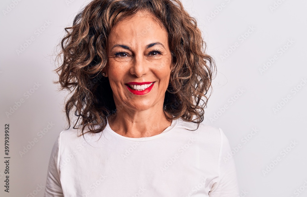 Middle age beautiful brunette woman wearing casual t-shirt standing over white background with a happy and cool smile on face. Lucky person. Middle age beautiful brunette woman wearing casual t-shirt standing over white background with a happy and cool smile on face. Lucky person.