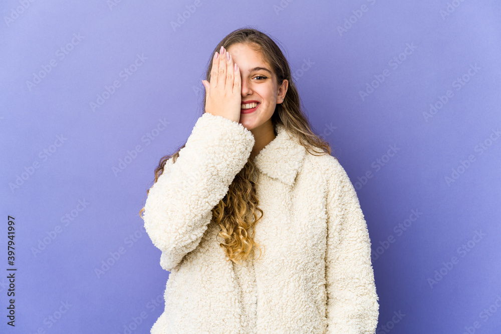 Young caucasian cute woman having fun covering half of face with palm. Young caucasian cute woman having fun covering half of face with palm.