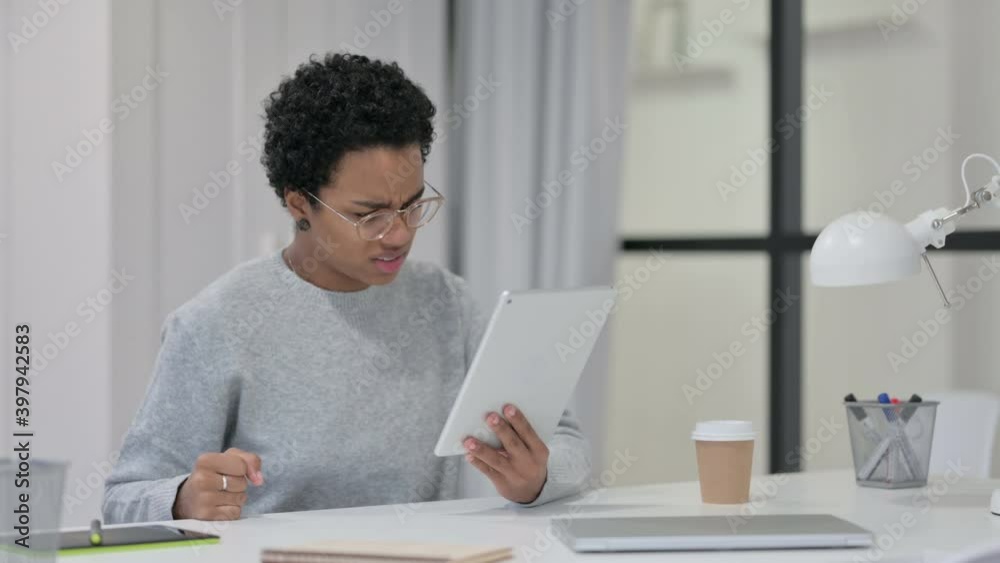 Disappointed African Woman Reacting to Loss on Tablet Disappointed African Woman Reacting to Loss on Tablet