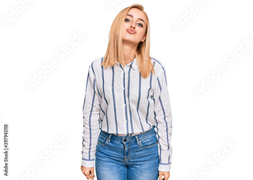 Beautiful caucasian woman wearing casual clothes looking at the camera blowing a kiss on air being lovely and sexy. love expression.