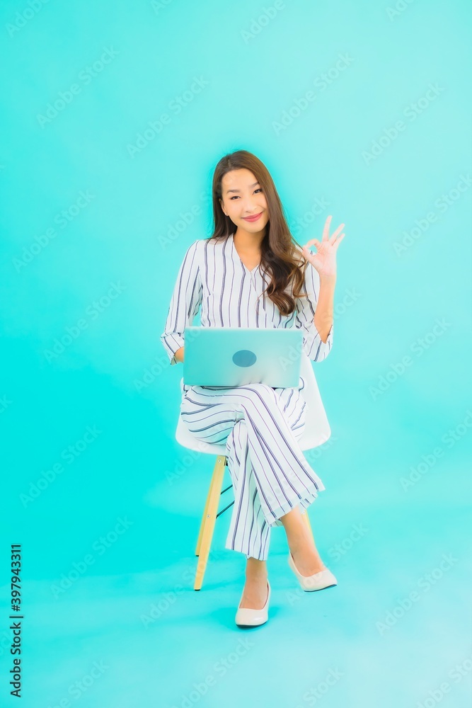 Portrait beautiful young asian woman use computer laptop and sit on chair Portrait beautiful young asian woman use computer laptop and sit on chair