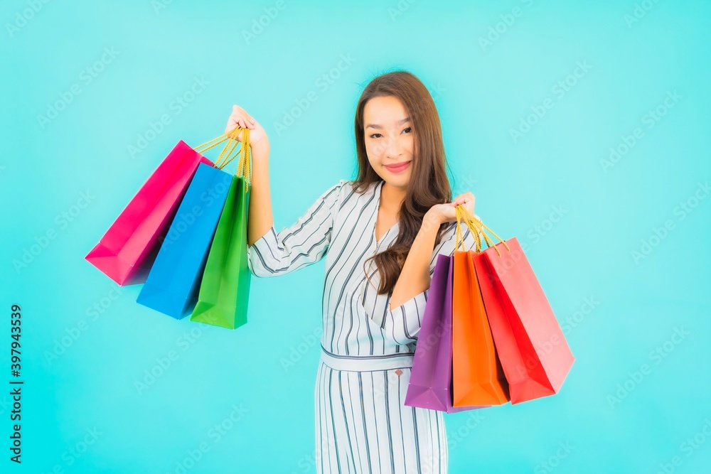 Portrait beautiful young asian woman with color shopping bag