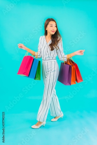 Portrait beautiful young asian woman with color shopping bag