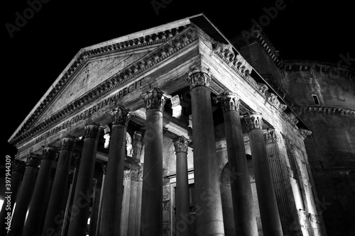 The monuments of rome in black and white at night.	