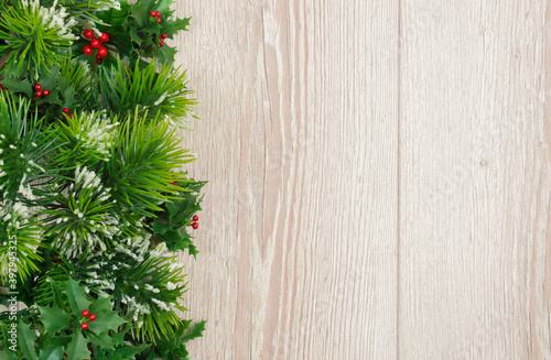 Christmas holiday background with empty wooden board and Christmas tree. Christmas composition with copy space. Flat lay