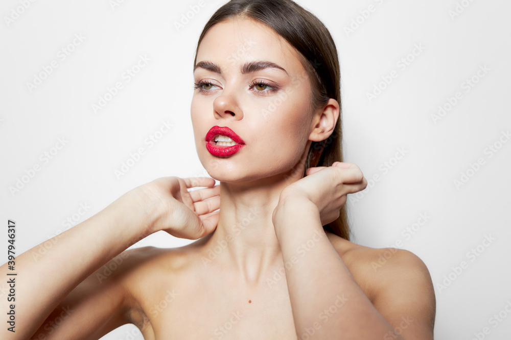 Model Red lips bared shoulders clean skin of hands near the face bright makeup Model Red lips bared shoulders clean skin of hands near the face bright makeup