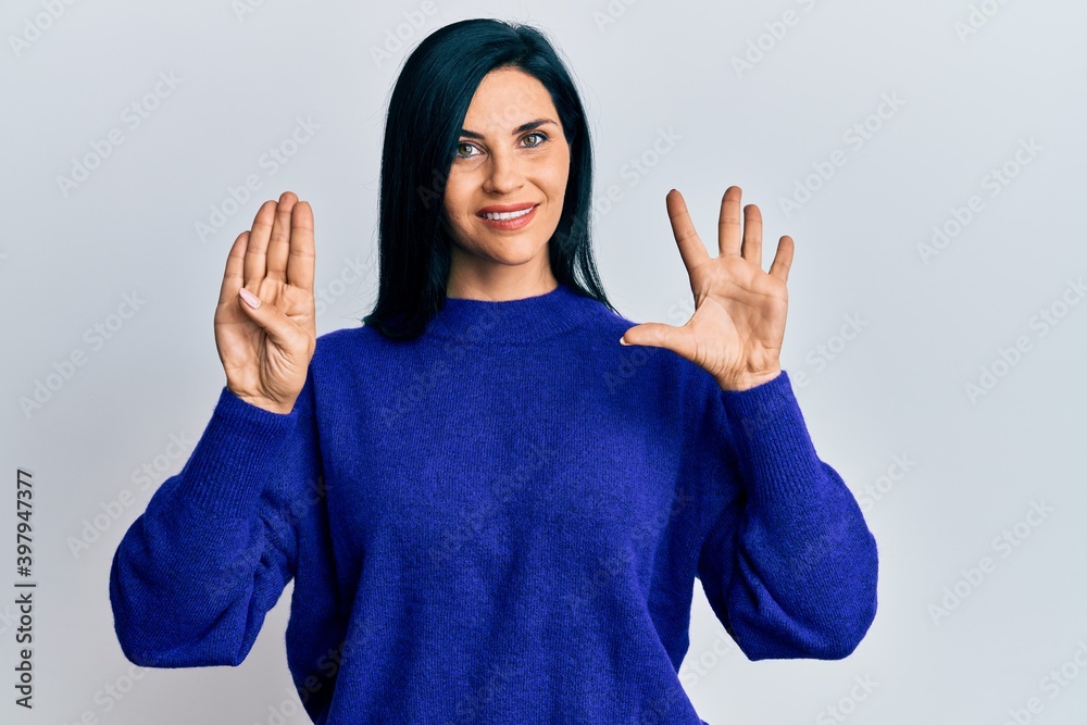 Young caucasian woman wearing casual clothes showing and pointing up with fingers number nine while smiling confident and happy. Young caucasian woman wearing casual clothes showing and pointing up with fingers number nine while smiling confident and happy.