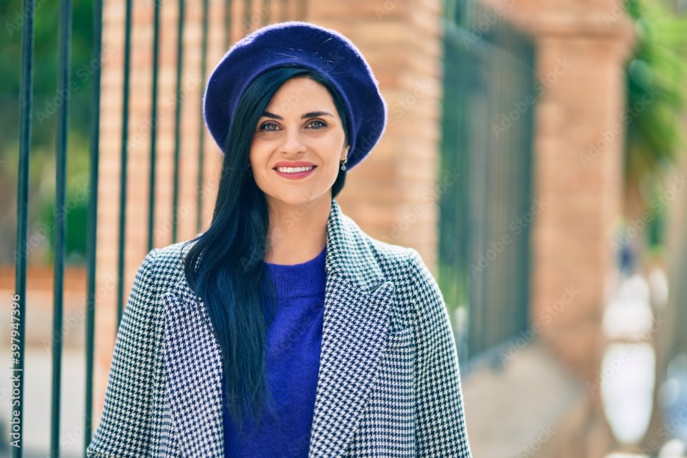 Young beautiful woman smiling happy wearing french style at the city. Young beautiful woman smiling happy wearing french style at the city.