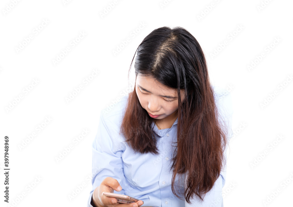 Long-haired girl in front of white background is looking down and playing with mobile phone Long-haired girl in front of white background is looking down and playing with mobile phone