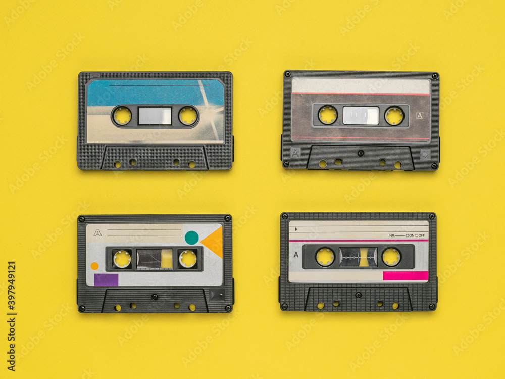 Four tape recorders on a yellow background. Four tape recorders on a yellow background.