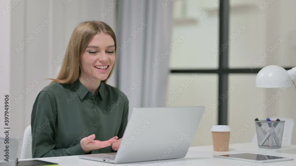 Young Woman Talking on Video Chat on Laptop Young Woman Talking on Video Chat on Laptop