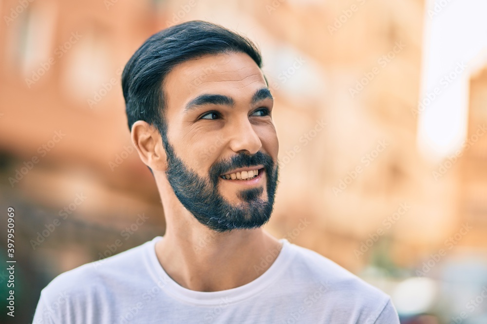 Young hispanic man smiling happy standing at the city. Young hispanic man smiling happy standing at the city.