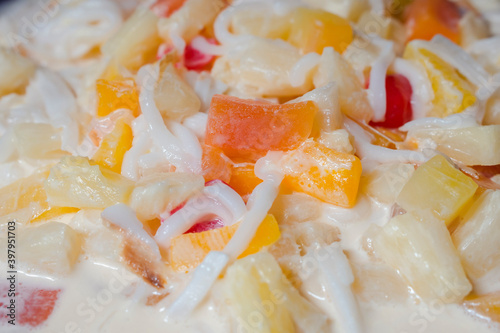 Closeup of Buko Salad, a Filipino fruit salad dessert made from strips of fresh young coconut with sweetened milk or cream, fruit cocktail and various other ingredients photo