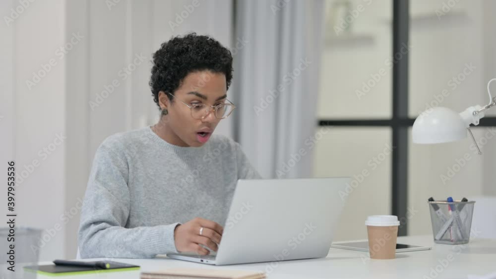 Young African Woman having Loss while using Laptop Young African Woman having Loss while using Laptop