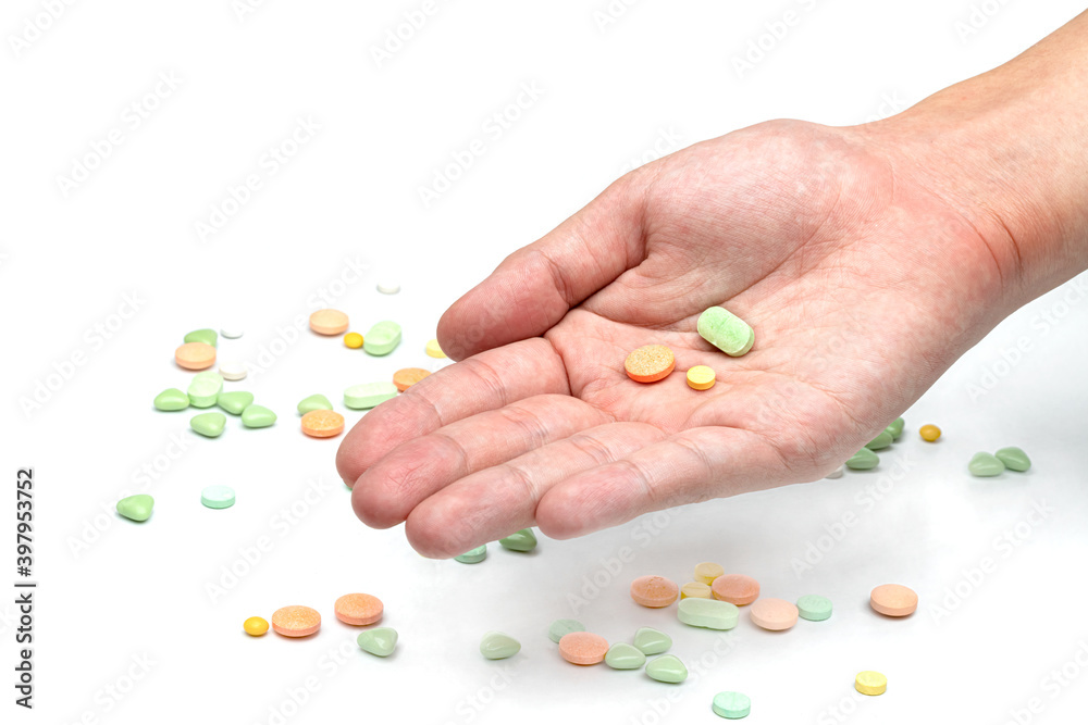 Hand holding pill isolated on white background Hand holding pill isolated on white background