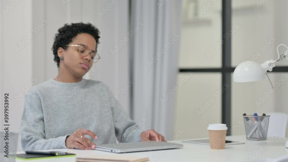 Young African Woman Coming and Opening Laptop Young African Woman Coming and Opening Laptop