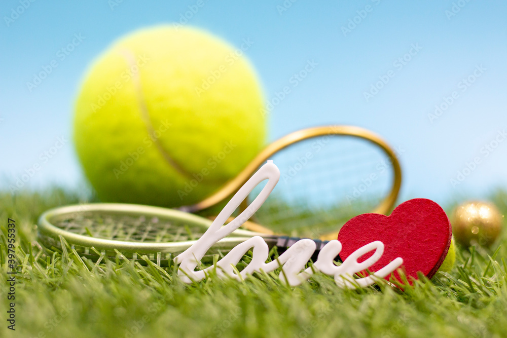 Love with tennis ball and rackets on blue background