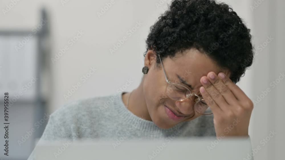 Portrait of African Woman having Headache while using Laptop Portrait of African Woman having Headache while using Laptop