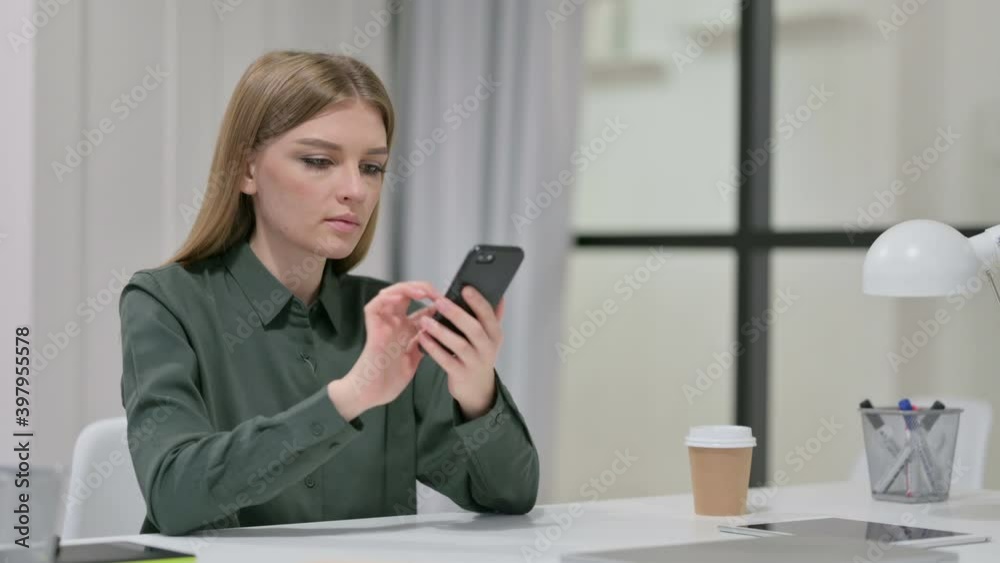 Attractive Young Woman using Smartphone at Work Attractive Young Woman using Smartphone at Work