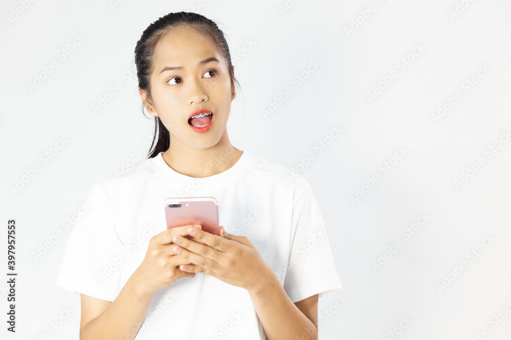 Image of excited young asia woman using and pointing finger at cellphone isolated over white background
Image of excited young asia woman using and pointing finger at cellphone isolated over white background