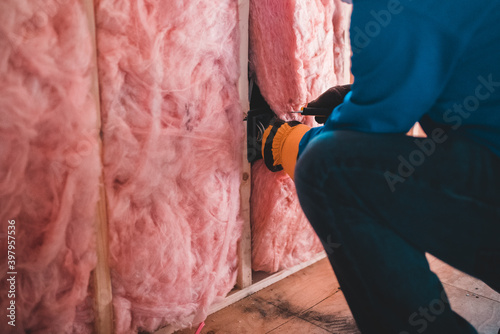 person installing insulation in a house photo