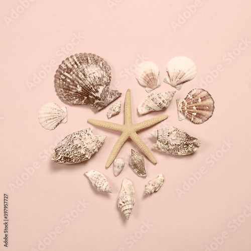 The shells are laid out in the shape of a heart. Toned monochrome image in trending color champagne sailing 2021