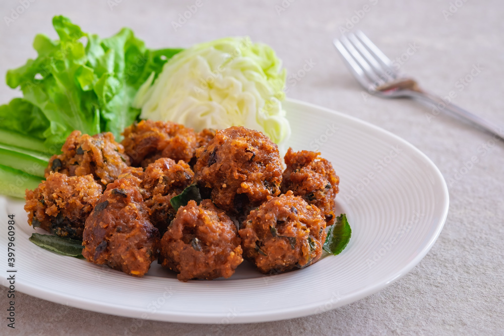 Deep fried spicy minced pork served with vegetable on plate, Thai food. Deep fried spicy minced pork served with vegetable on plate, Thai food.