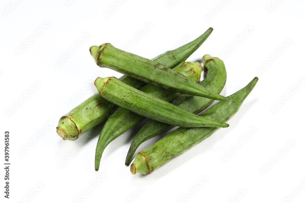 Pile of fresh and organic Okra isolated on the white background. Famous local herbal vegetable in Asia restaurant. Pile of fresh and organic Okra isolated on the white background. Famous local herbal vegetable in Asia restaurant.