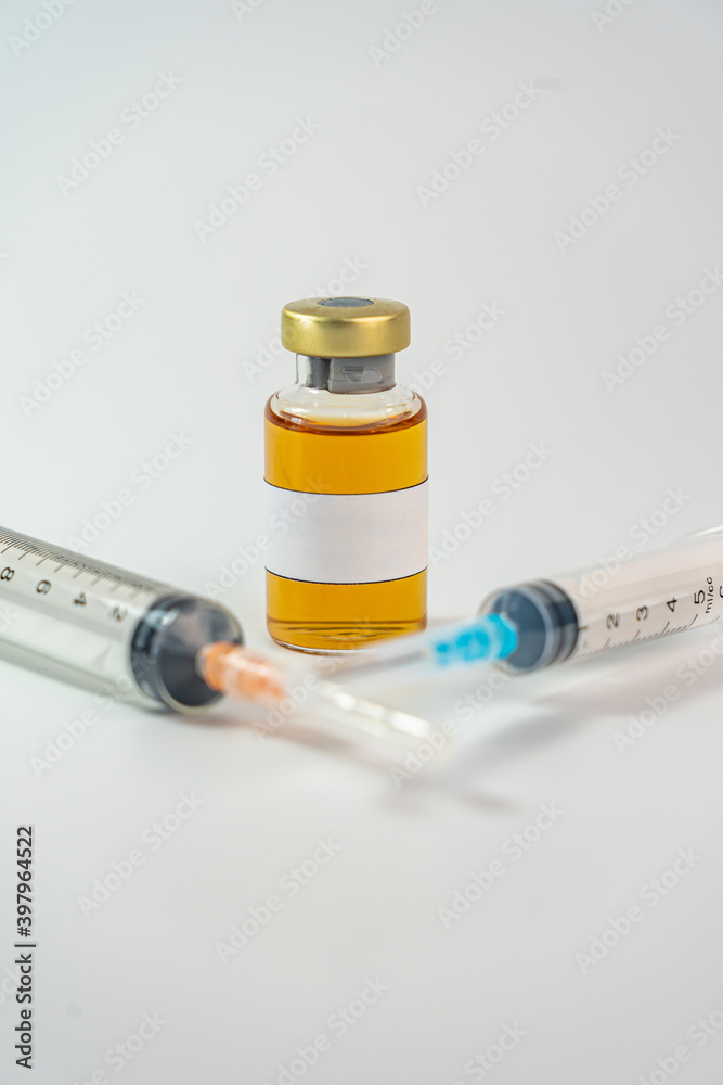 Blank label on vaccine bottle and medical syringe injection Blank label on vaccine bottle and medical syringe injection