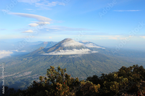 beautiful sindoro mountain with blue sky and cloud, in java indonesia, nature landscape photo background wallpaper photo