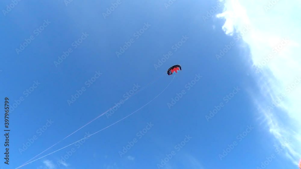 Power kite flying across a blue summer sky Power kite flying across a blue summer sky