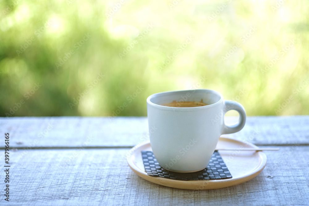 Hot coffee cup on wood table with blur nature background. Hot coffee cup on wood table with blur nature background.