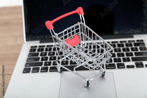 An empty shopping cart model on a laptop keyboard