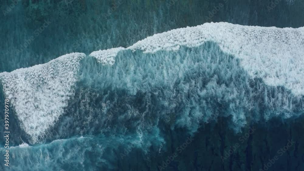 Slow motion top view of sea foamy bewitchingly splashing waves on a gloomy summer day. Concept of the beauty of nature and the power of the elements