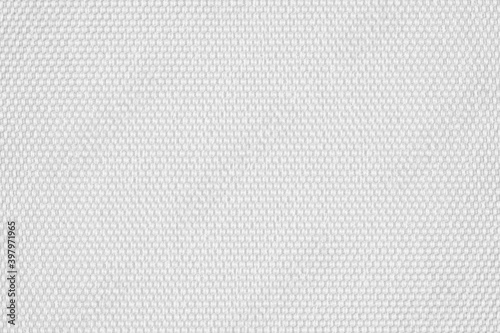 White fabric background. White canvas texture. Bright textile material background. Soft fiber closeup. Simple white surface. Geometrical pattern.