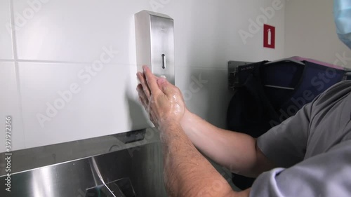 Surgical team scrubbing in before going to operation. Surgeon washing hands before operation. Hospital surgical team preparing for surgery at medical center. Medical professionals at work in scrubs