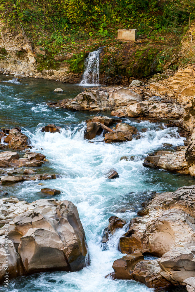 Landscape with a mountain river flowing through canyon