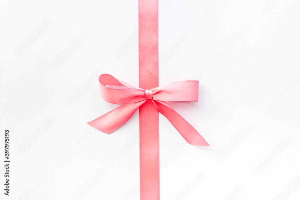 Pink ribbon with bow isolated on white. Top view, copy space Pink ribbon with bow isolated on white. Top view, copy space