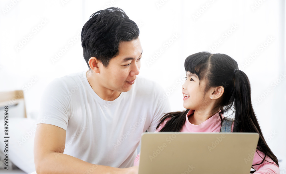 Father and daughter learning education study online class. Kid girl and dad using computer laptop at home Father and daughter learning education study online class. Kid girl and dad using computer laptop at home