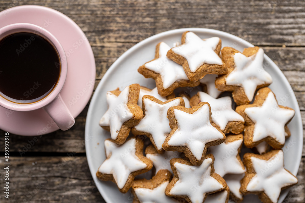 Icing gingerbread stars. Traditional Christmas cookies and coffee cup. Icing gingerbread stars. Traditional Christmas cookies and coffee cup.