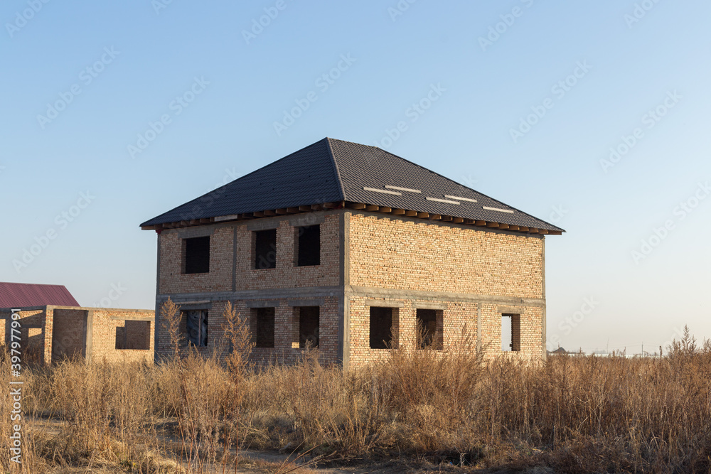 unfinished two-story brick house in nature unfinished two-story brick house in nature