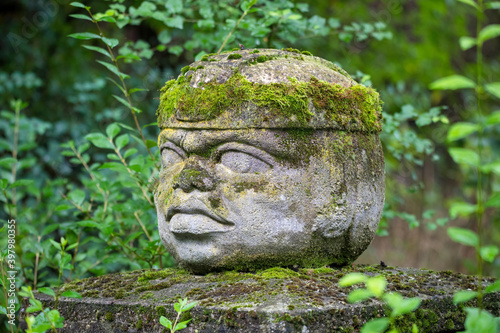 Фотография Replica of Olmec civilization Sculpture, colossal head carved from stone in forest