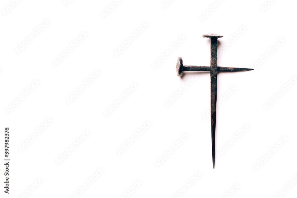 Cross made with rusty nails and drops of blood on white background. Copy space. Good Friday, Easter day. Christian backdrop. Biblical faith, gospel, salvation concept. Crucifixion of Jesus Christ