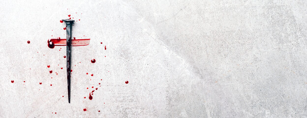 Christian cross made with rusty nails, drops of blood on grey background. Copy space. Good Friday, Easter day. Christian backdrop. Biblical faith, gospel, salvation concept. Jesus Christ Crucifixion