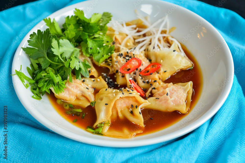 Boiled meat dumplings with fresh parsley, soy sauce and sesame seeds. Delicious meal for dinner. Boiled meat dumplings with fresh parsley, soy sauce and sesame seeds. Delicious meal for dinner.