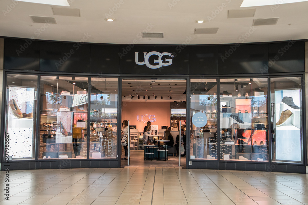 Exterior of Ugg fashion clothing store shop showing company logo, sign