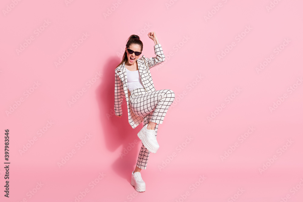 Full length photo of young beautiful girl excited happy positive celebrate win victory goal wear pants isolated over pink color background Full length photo of young beautiful girl excited happy positive celebrate win victory goal wear pants isolated over pink color background